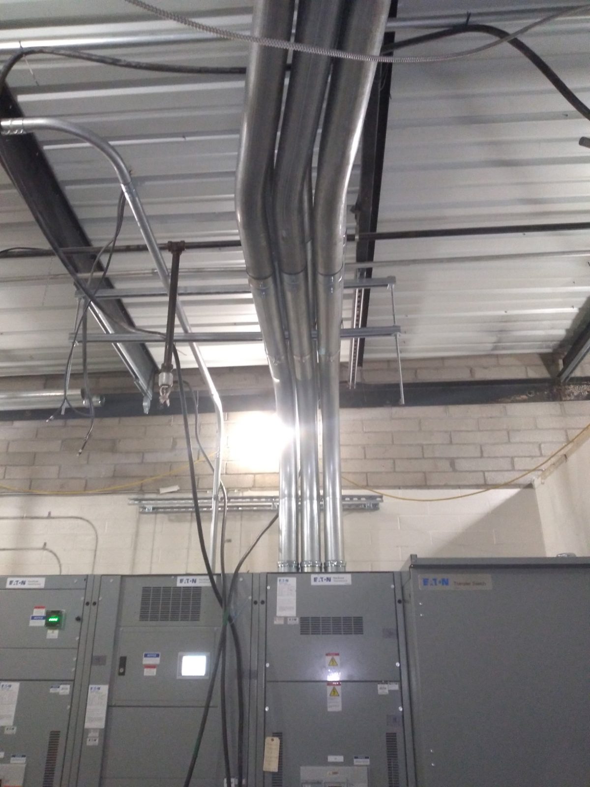 Conduit bank turning out of the ceiling and dropping into switchgear