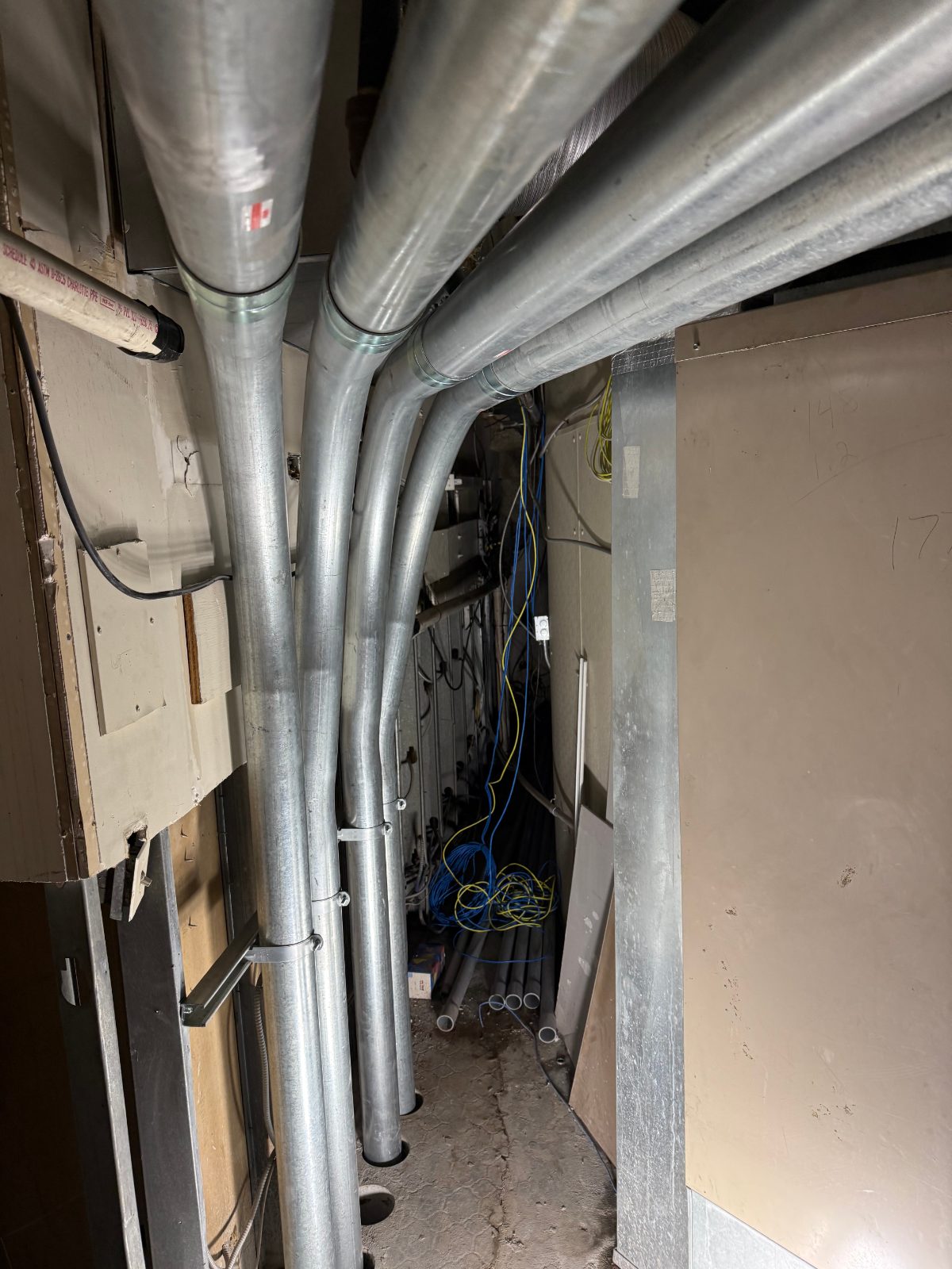 A bank of matched conduit 90s sweeping across a wall into gear